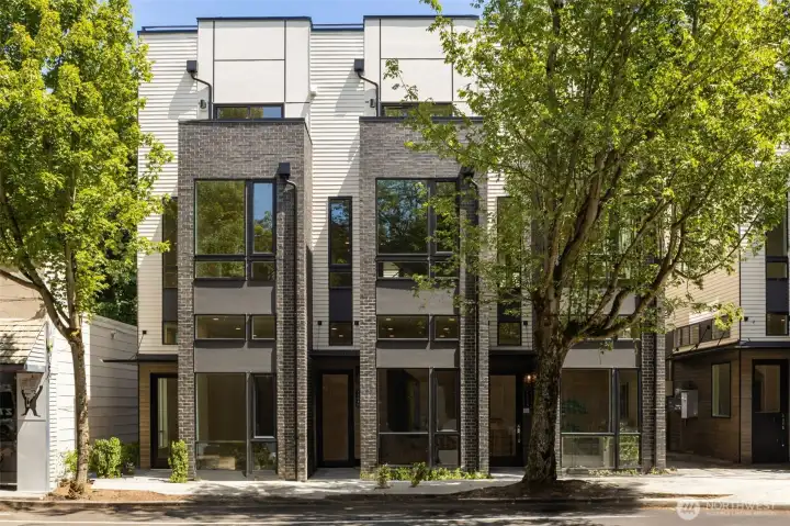 A striking display of modern architecture in the heart of one of Seattle’s most cherished neighborhoods. This bold corner residence showcases clean lines, oversized windows, and lush landscaping—perfectly positioned to offer quiet elegance just steps from the buzz of Madrona’s retail core.
