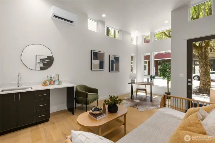 Bright, open-concept living area with oversized windows and elegant finishes.