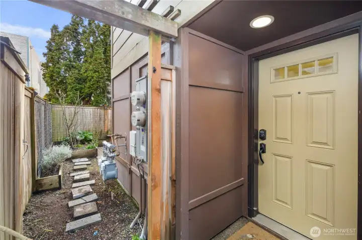 Main Entry door with access gate open to backyard