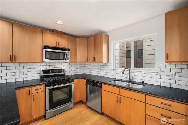 Cooks kitchen with gas range.