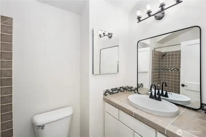 Fully tiled Primary Bathroom with Skylight!
