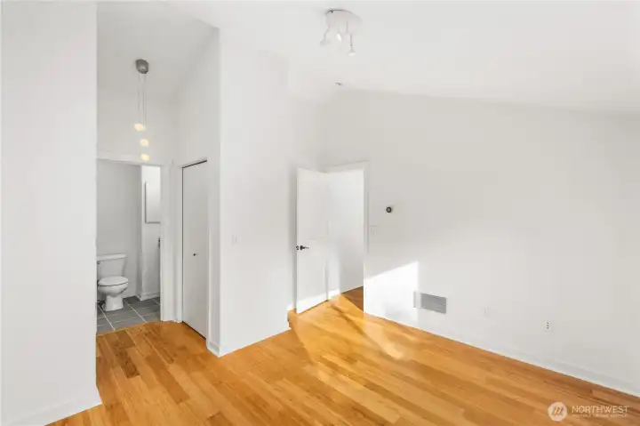 Primary bedroom with his-her closets and access to fully tiled bath.