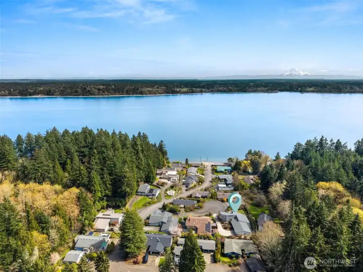 Looking out over the home, you’ve got water in the foreground and Mount Rainier rising in the distance, which never really gets old. The neighborhood itself reads as a quiet enclave of custom homes, well cared for and thoughtfully maintained, with that consistent sense of pride you hope to see. It feels tucked away without being isolated. There’s also some real substance behind the scenes here, with the gas furnace and air conditioning system replaced in 2023, adding comfort and confidence to match the setting.