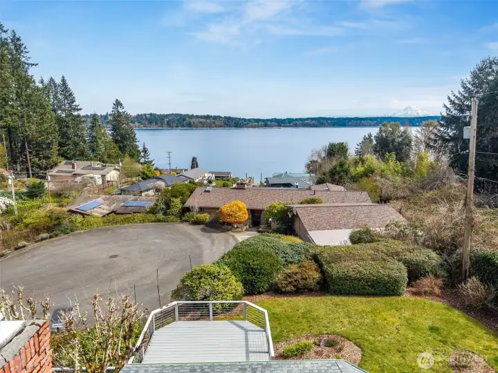 You can see how it all comes together, the deck overlooking the yard, the quiet cul-de-sac, and the water stretching out beyond with Mount Rainier in the distance. It’s a peaceful, tucked-away setting that feels intentional. And then there’s the part that makes daily life easier. This neighborhood runs on a community water system through Thurston County and a shared sewer system maintained by the HOA, so no individual well or septic to manage. The $237/month dues cover more than you might expect, private dock and beach access, road maintenance, insurance, common areas, plus your water and sewer. When you look at it that way, it’s less about dues and more about bundled convenience with some pretty great perks.