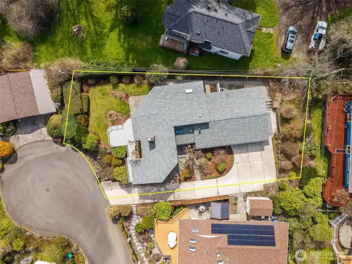 A closer look from above brings out some of the thoughtful details you might not notice at first glance. The newer roof, installed just four years ago, adds a solid layer of confidence knowing it’s built to last. Surrounding the home is a full concrete perimeter walkway, which is one of those features that quietly makes life easier. Whether you’re doing upkeep, moving around the yard, or just trying to stay dry on a damp day, it’sincredibly useful. It even ties directly into the exterior access from the primary suite, creating a continuous path that feels both practical and well planned.