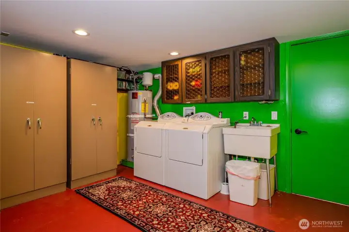 Laundry room with lots of storage and finished storage room with separate door to outside.