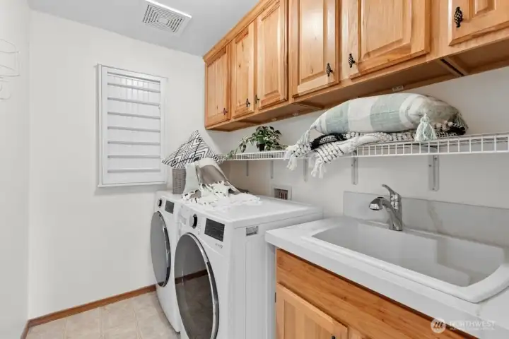Convenient upstairs laundry room with plenty of storage and sink!