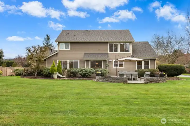 A sprinkler system, rose garden behind wrought iron fencing,vegetable garden area, and perennials galore!