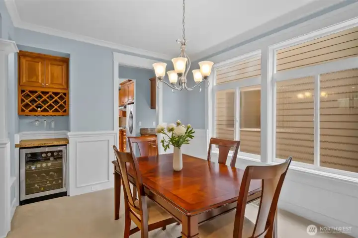 Wine bar with built in wine rack and upper cabinets.  Walk-through prep-area and pantry provide for additional storage and counter space with easy access to the kitchen.