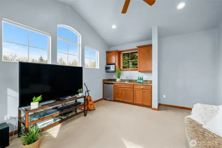 Another view of the upstairs bonus/flex space and wet bar/kitchenette.  There are ample windows for natural light.