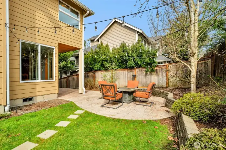 Patio and garden space with stepping stones to the greenhouse.