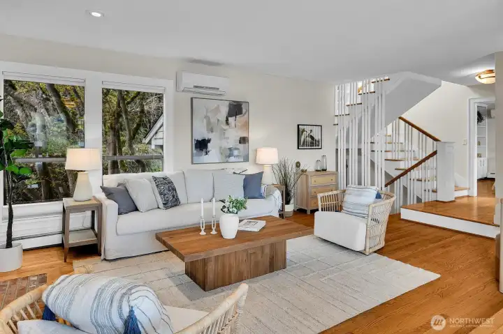 With honey oak floors and a view toward Burke Gilman Trail, the spacious living area awaits.