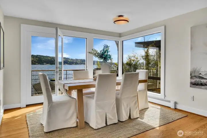 The dining area is set for 6 and opens to an outdoor deck.
