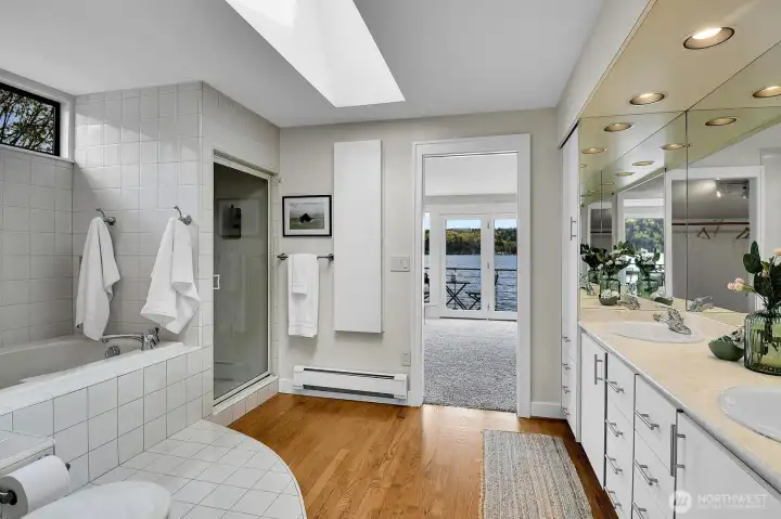 The primary bath includes a jetted tub and a shower, as well as double sinks. There's also a skylight above. And plenty of storage!
