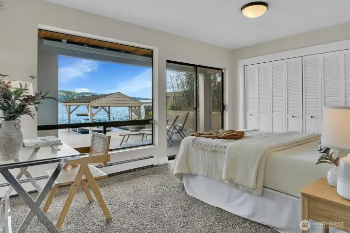 The guest bedroom on the lower level glows with natural light and offers views with easy access to the patio.