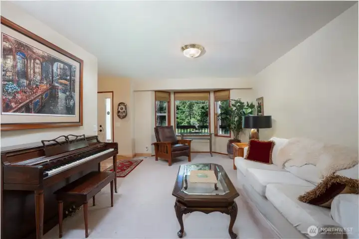 Living room with main entry to the rear left in the photo.