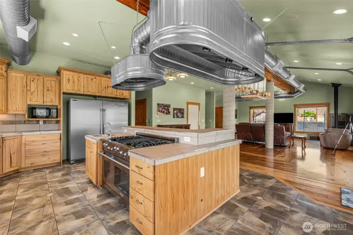 A chef would be in heaven with this gas professional 6 burner stove, its whimsical lighting, oversized refrigerator and dual convection ovens.