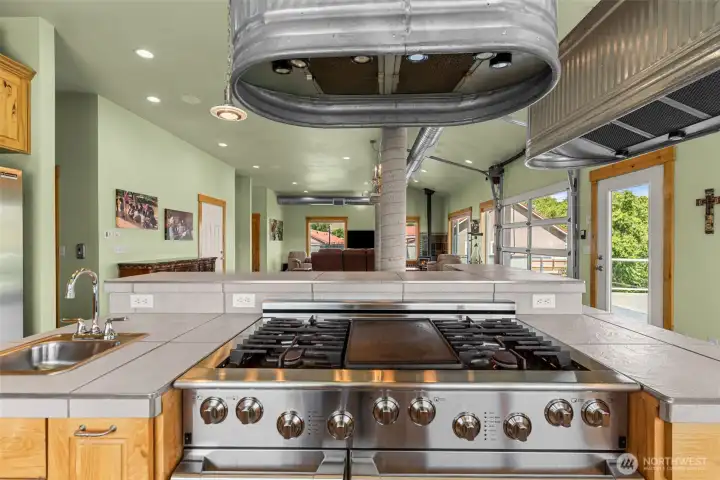 6 burner stove with duel convection ovens, prep sink on the left.