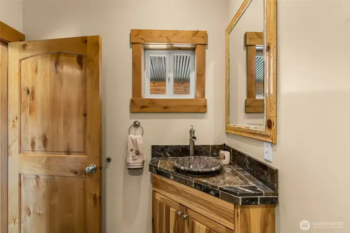 The second main floor half bath is just inside the front main entrance, right off of the living room.