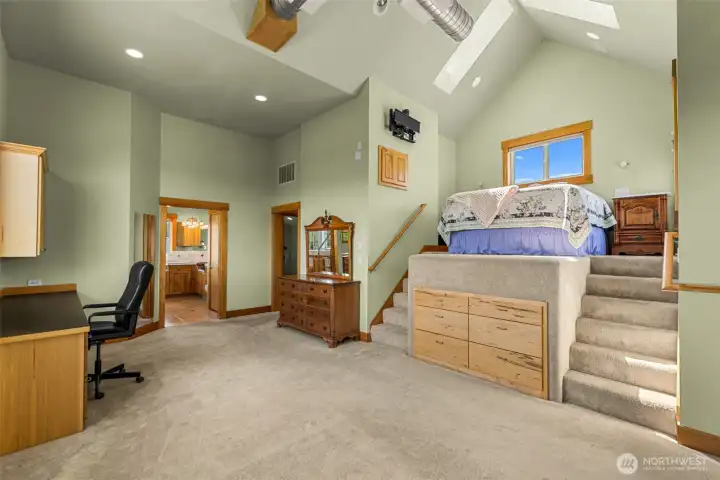 The primary suite features a step up platform bed, room for adding a work area a large enclosed deck, a delux his and her's restrooms and walk in closets.