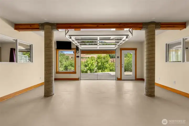 The lower level features the overhead door, this is a bonus room which is situated between the two guest bedrooms suites.