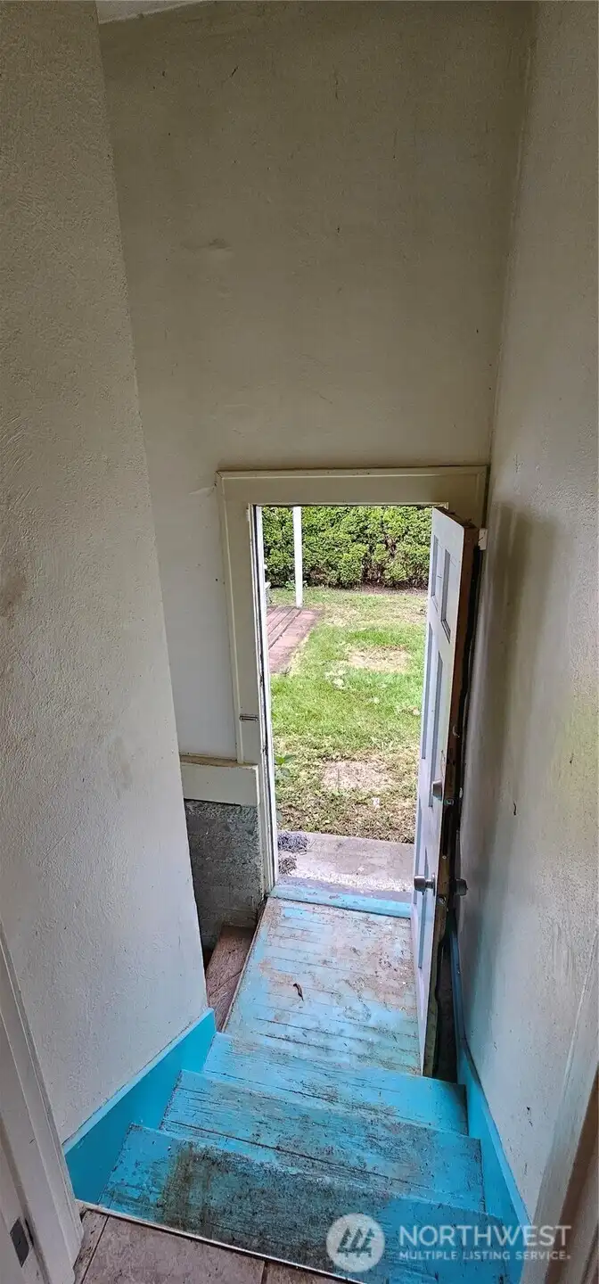 Stairs to basement with seperate exterior door.