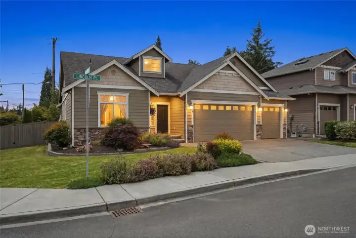 Inviting curb appeal featuring beautiful landscaping and a 3-car garage.