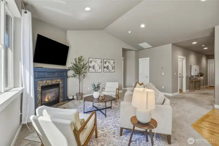 Vaulted ceilings, a gas fireplace, and an inviting living area.