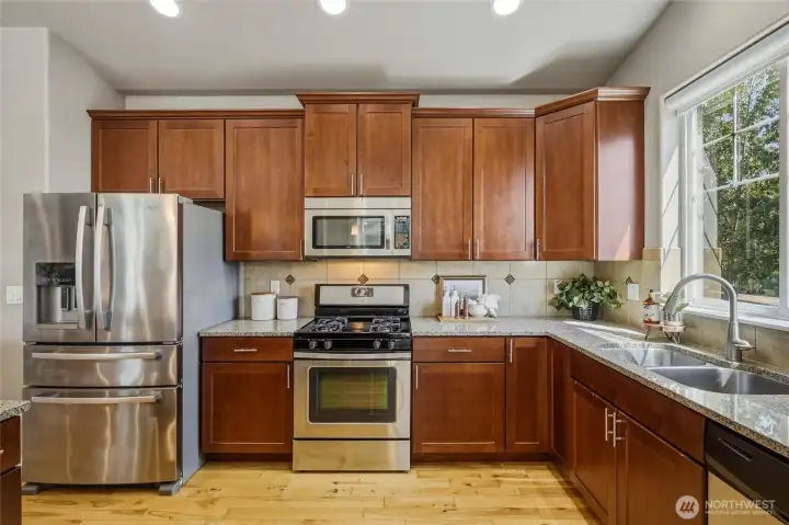 Granite countertops, stainless steel appliances, and abundant cabinetry.