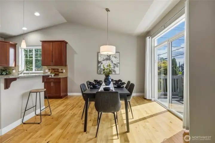 Dining area with sliding glass door and breakfast bar.