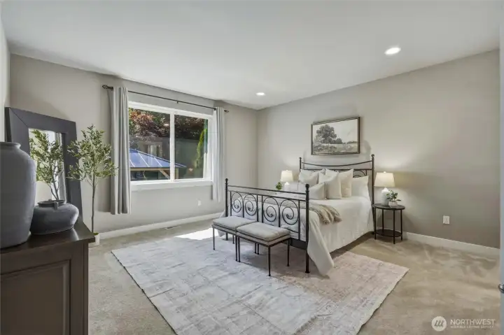 Spacious primary bedroom with abundant natural light.