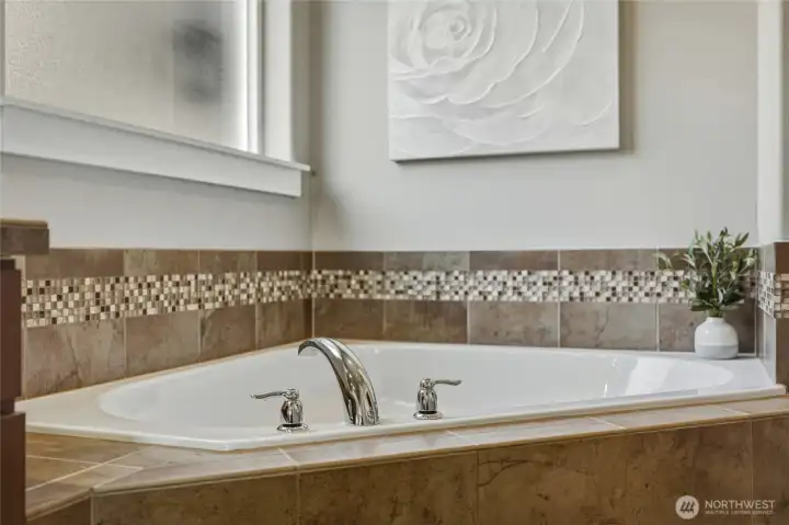 Spa-inspired soaking tub with elegant tile surround.