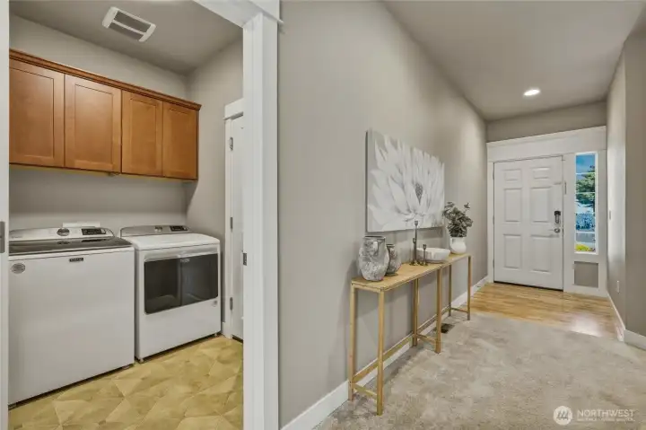 Dedicated laundry room with upper cabinets for extra storage.
