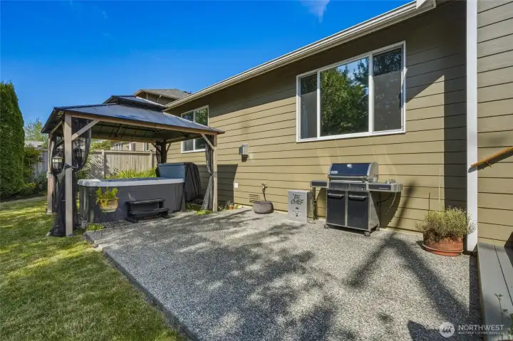Private patio with a gazebo-covered hot tub and BBQ area.
