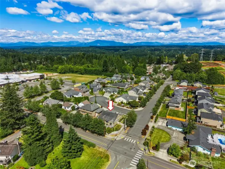 Aerial view highlighting the home’s desirable corner lot location in a welcoming neighborhood, just minutes from downtown Snohomish with scenic mountain views beyond.