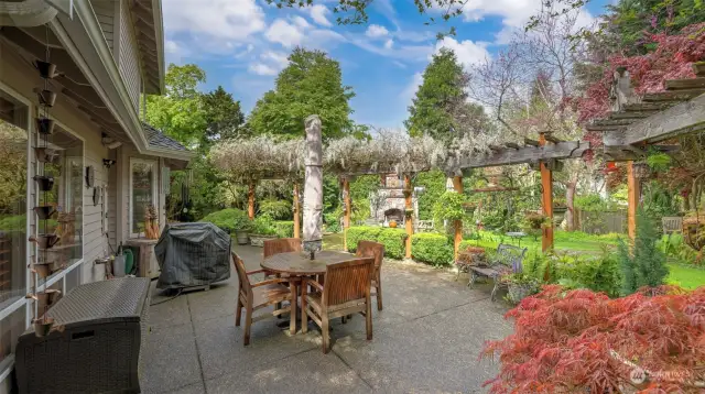 Beautiful backyard, perfect for entertaining.  Mature Wisteria plants frame the patio.