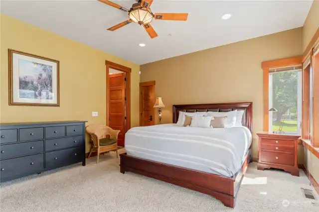 Lower level bedroom 3 w/ on-suite bath, walk-in closet and doors leading to the waterfront view deck.