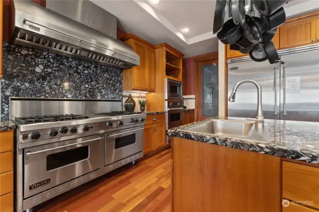 Kitchen view 1 w/ Viking® Professional appliances, wood cabinetry, walk-in pantry and granite countertops.