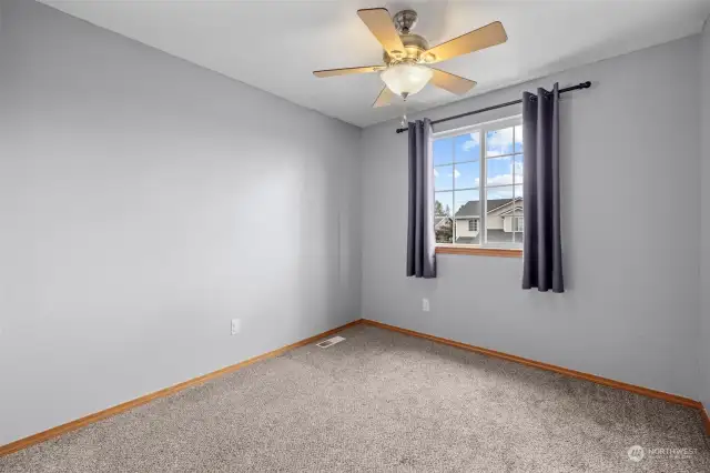 Third upper level bedroom with ceiling fan, city scape and territorial views.