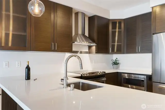 Kitchen has upgraded stainless appliances, a drawer microwave, wine fridge and glass faced cabinets