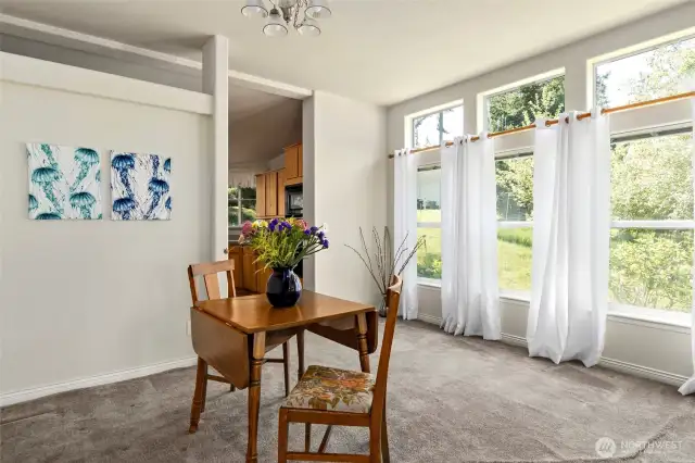 The dining room has a wall of windows to bring in the sunshine.