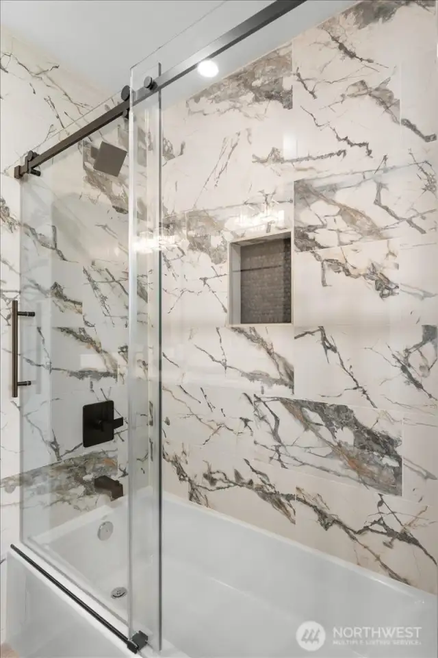 Main bathroom bathtub/shower with stunning tile with barn doors