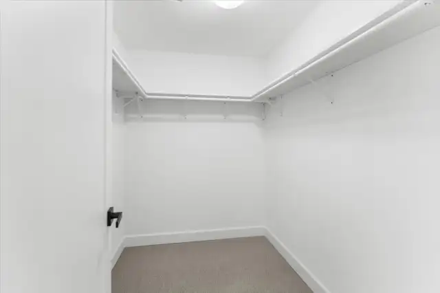 Primary bedroom walk in closet
