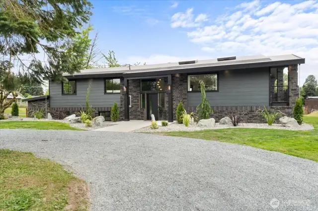Front exterior with circle driveway.