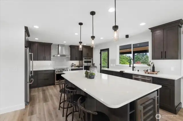 Oversized Island with quartz countertops.  Wine racks and beverage fridge.
