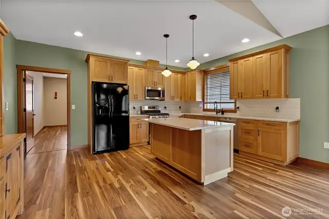 Closer look at the tile backsplash and the plethora of cabinets.