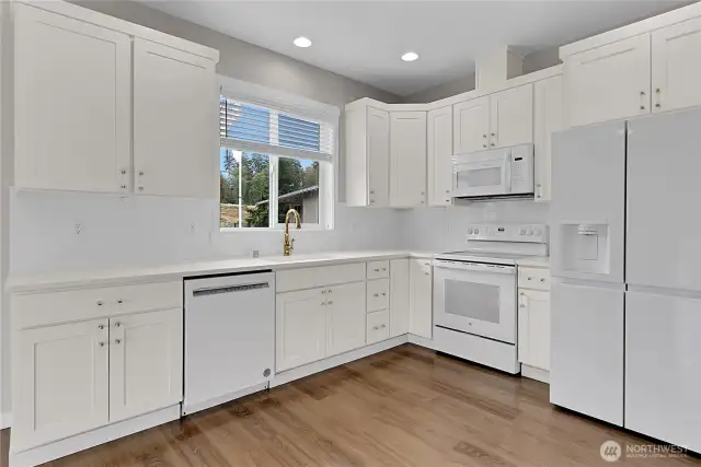 The kitchen boasts lots of cabinets and counter space