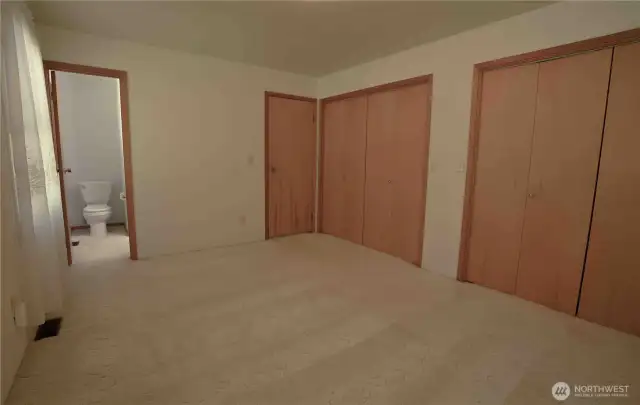 Master bedroom with lots of storage space. Beautiful wooden closet doors throughout.