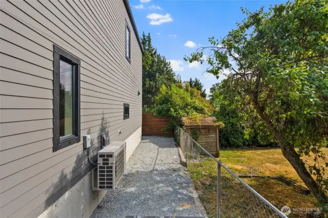 Additional yard. Level & hard panned gravel, this is a great space to add a shed.