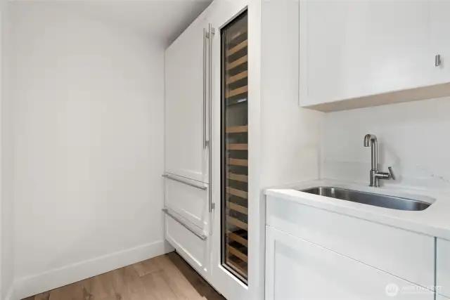 Located next to the media room, SubZero fridge, drink cooler and, sink and plenty of storage and counters.